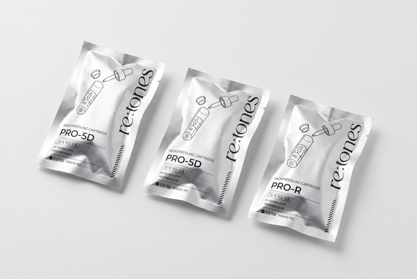 Three sealed re:tones cartridge pouches lying on a plain surface