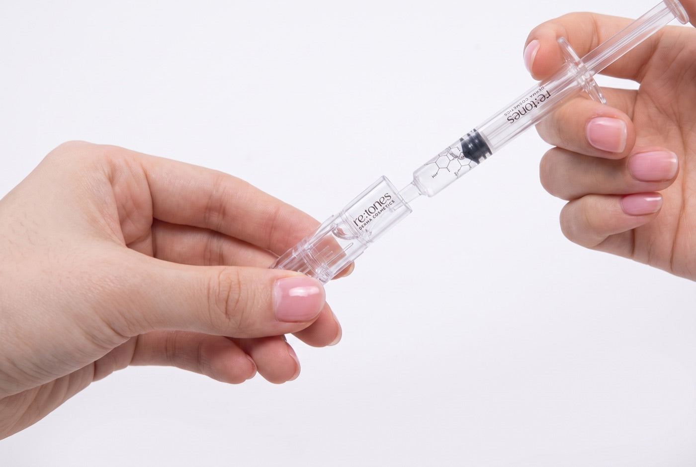 An ampoule being emptied into the open cartridge