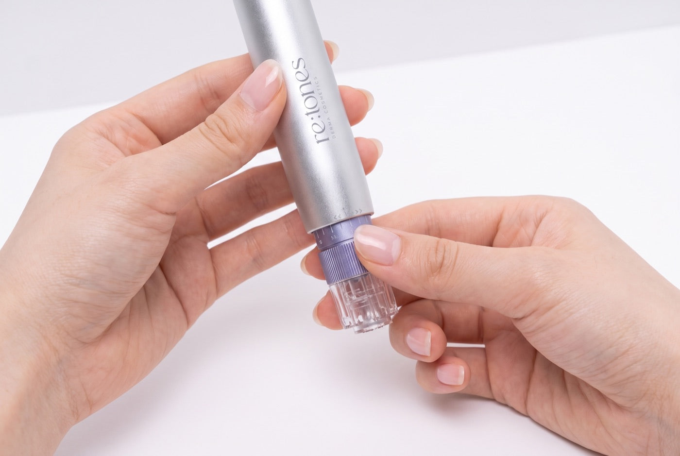 A hand turning the depth collar on the device